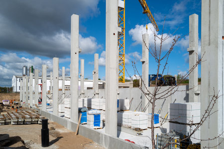 many concrete pillars for a factory building are erected on a construction siteの写真素材