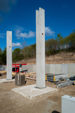 many concrete pillars for a factory building are erected on a construction siteの写真素材