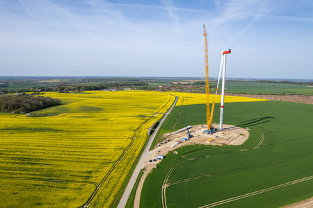 a new wind turbine is erected on a fieldの写真素材