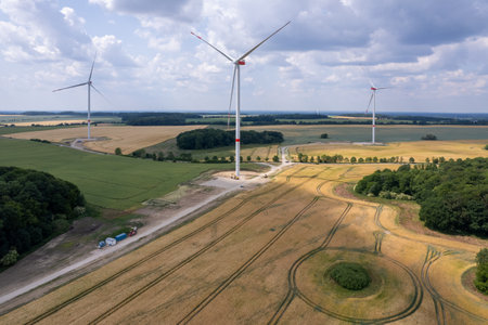 on a green field in Mecklenburg stood newly erected wind turbinesの写真素材