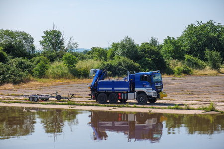 a vehicle of the German THW stands next to a riverの写真素材