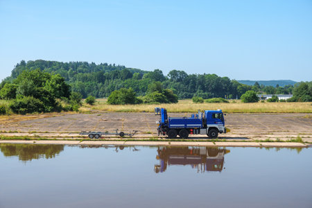 a vehicle of the German THW stands next to a riverの写真素材