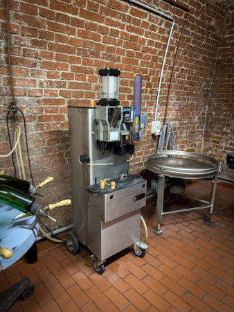 in an old champagne cellar there is a machine for closing champagne bottlesの写真素材