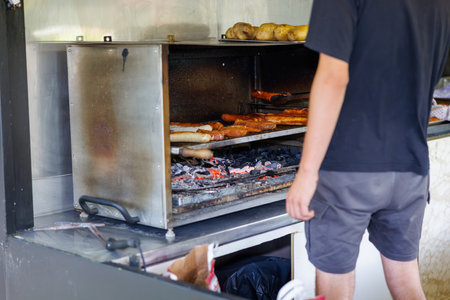 Delicious sausages are prepared on a charcoal grillの写真素材