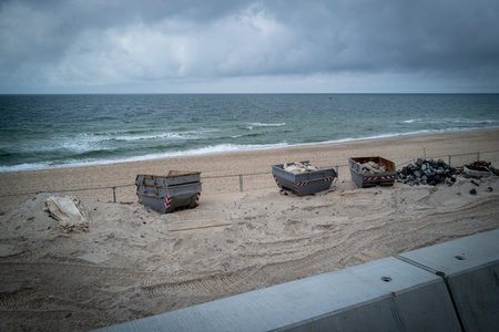 at the beach of Westerland on the island of Sylt there are some garbage containersの写真素材