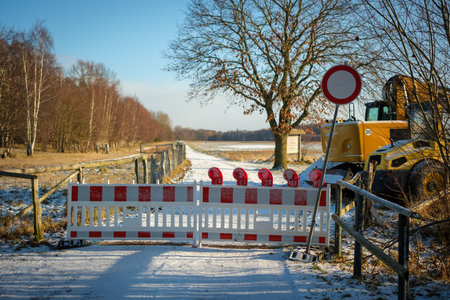 A path is blocked by a barrier and a traffic signの写真素材
