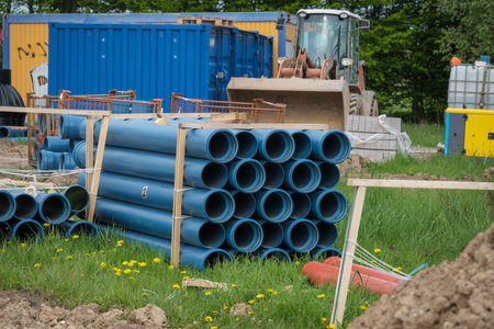 There are many blue pipes on a large construction siteの写真素材