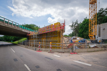 construction site with scaffolding on the side of the road.
