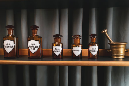 there are several small old pharmacy bottles on a shelfの写真素材