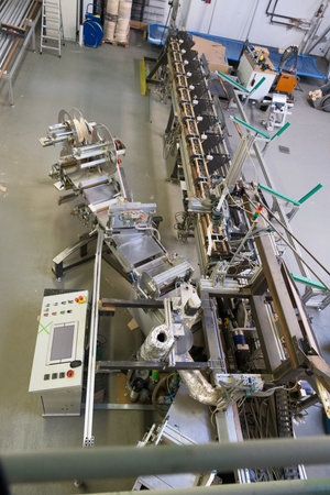 a complex machine stands in a factory hall