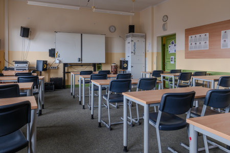 A classroom full of tables and chairsの写真素材