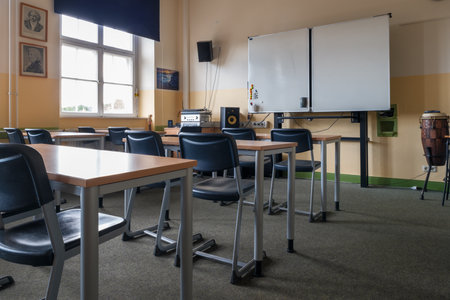 A classroom full of tables and chairsの写真素材