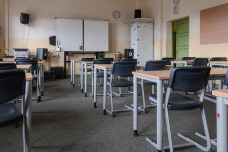 A classroom full of tables and chairsの写真素材