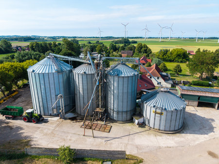 4 large silos are located on a farmの写真素材