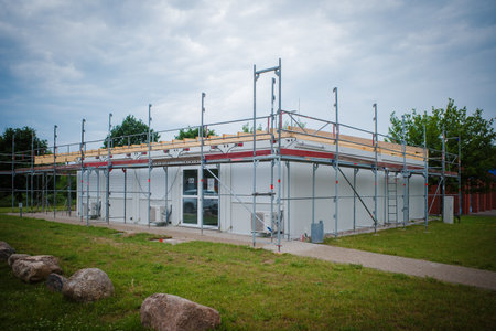 a container house is scaffolded with scaffoldingの写真素材