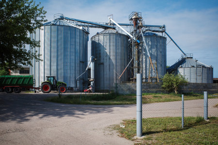 4 large silos are located on a farmの写真素材