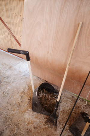 the Horse manure is swept up with a shovel and broomの写真素材