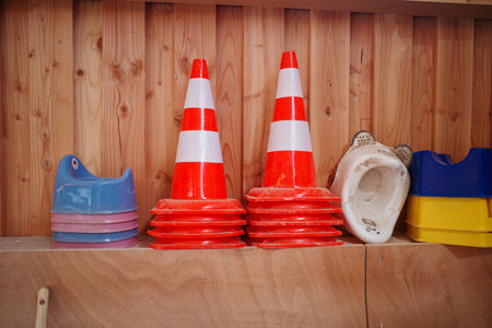 Some pylons and baby potties are stacked on a shelfの写真素材