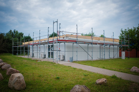 a container house is scaffolded with scaffoldingの写真素材