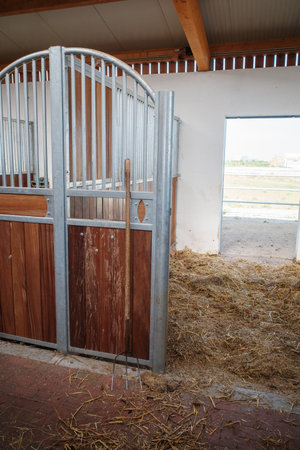 A fork stands in front of an empty horse boxの写真素材