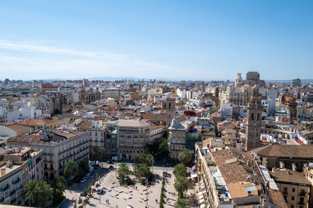 Aerial panoramic view of Valencia, Spain, showcasing the historic old town with its traditional Mediterranean architecture, colorful rooftops, and iconic blue-domed churches under a clear blue sky. The vibrant urban landscape highlights the unique blend of cultural heritage and modern city life, making it a popular travel and tourism destination on the Spanish Mediterranean coast.の写真素材