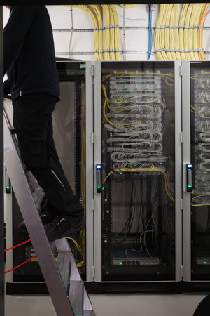 Detailed view of a modern server room with network cabinets full of organized fiber-optic and...
