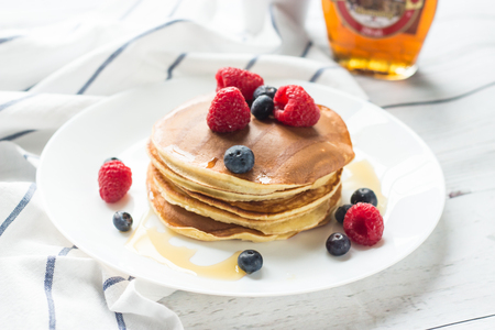 Breakfast. Berries. Pancakes. Romantic breakfast on a wooden table. Spring morning. Cozy.の写真素材