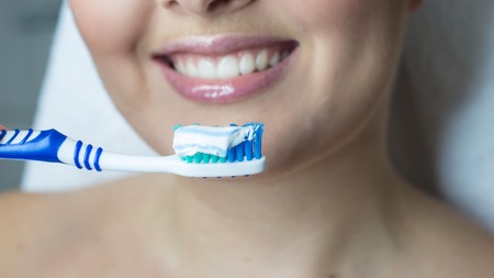 Young beautiful woman holding a toothbrush. Close-up photo.の写真素材
