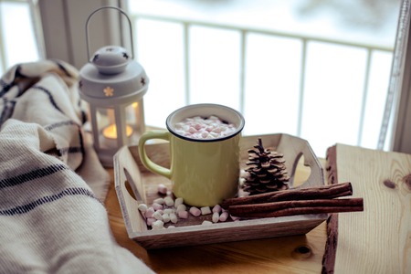 Mug of hot cocoa with marshmallow. Breakfast by the window. Christmas mood. Holidays. A cozy evening. Winter evening. Autumn.の写真素材