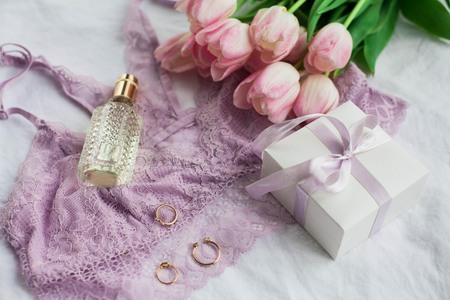 Beautiful lace lingerie. Cosmetics, decorations, a bouquet of tulips. Gift. A box with a gift. International Women's Day. Holidays. Spring. Cozyの写真素材