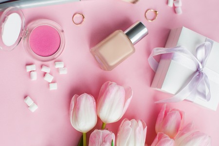 Cosmetics, decorations, a bouquet of tulips on a pink background. Gift. A box with a gift. International Women's Day. Holidays. Spring. Cozyの写真素材