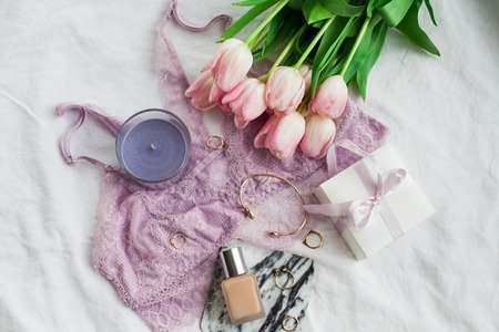 Beautiful lace lingerie. Cosmetics, decorations, a bouquet of tulips. Gift. A box with a gift. International Women's Day. Holidays. Spring. Cozyの写真素材