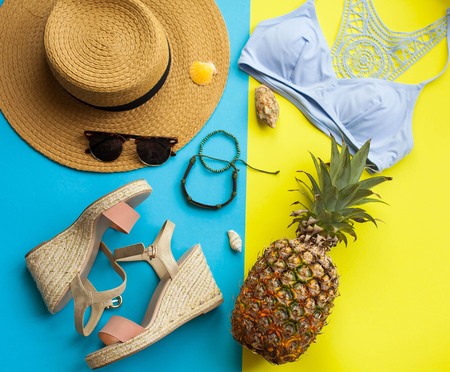 Summer beach accessories. Straw hat, sunglasses, pineapple. Summer Bright Yellow backgroundの写真素材