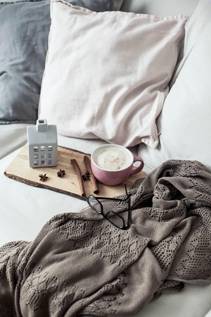 Home decor. Mug cappuccino, plaid, wooden tray, sofa Cozy Autumn Fallの写真素材