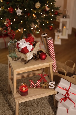Christmas mood. Gifts, wrapping paper, candles, Christmas tree. Scenery. Holidays. Christmas. New Year.の写真素材