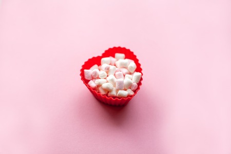 Red heart shape with marshmallows on pink background. Valentine's Day. Love.の写真素材