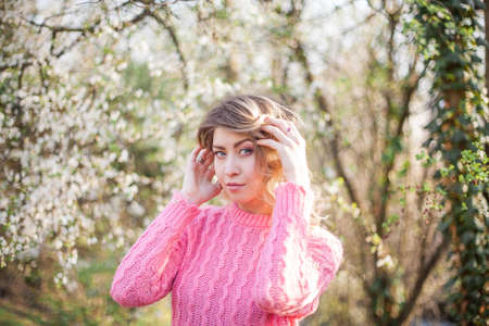 Portrait of a beautiful young woman near a magnolia.の写真素材