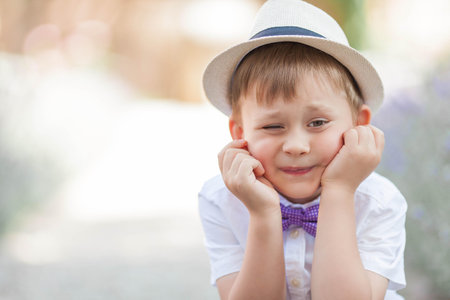 A little boy of 5 years old walks in a flowered park. Lavender. Spring.の写真素材