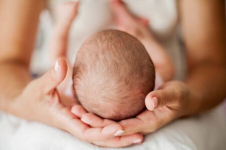 Mom holds a baby in her arms. Close-up. Baby.の写真素材
