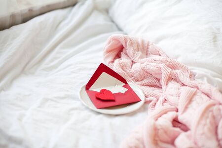 Pink knitted plaid greeting card with Valentine's Day. Spring.
