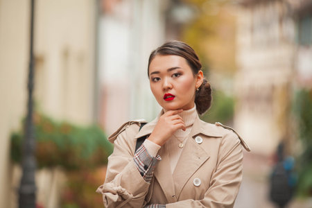 A beautiful young Asian woman walks in a European city. Spring.の写真素材