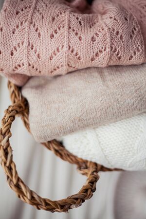 Wicker rattan basket with clothes. Natural organic materials. Homeliness. Cozy.の写真素材