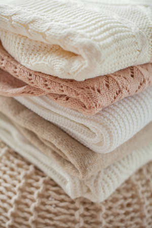 Knitted sweater. Women's sweaters lie on the ottoman. Cozy autumn clothes. Fall.の写真素材
