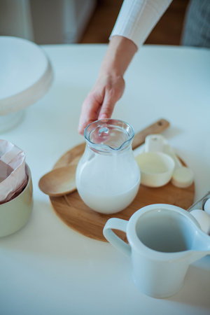 Young beautiful woman bakes a cake. Sweets.の写真素材