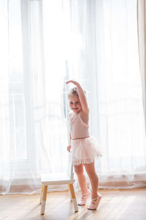 Online classes. The little girl is engaged in ballet. Dancing. Home.の写真素材