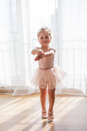 Online classes. The little girl is engaged in ballet. Dancing. Home.の写真素材