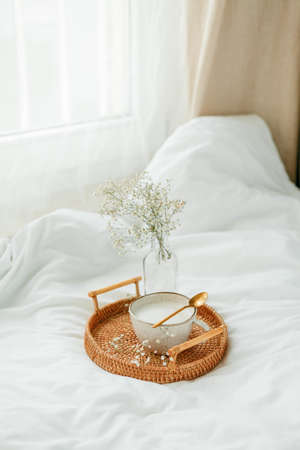 Home office, work, female hands, cappuccino, wicker tray, spring, home decor, laptop, notebook.の写真素材