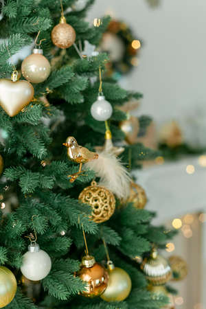 Living room with Christmas decorations. Christmas tree, gift boxes, cozy armchair, pillows, fireplace. Cozy.の写真素材