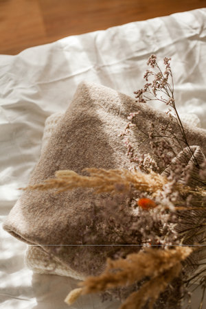 Cozy home decor. Warm winter clothing. Bouquet of dried flowers. women things.の写真素材