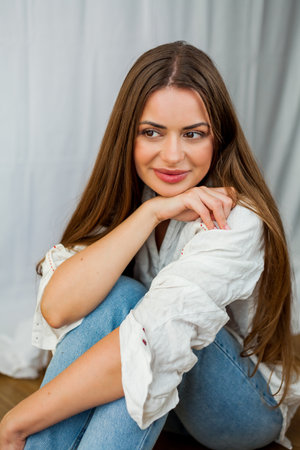 Portrait of beautiful young woman with long hair on white background.の写真素材